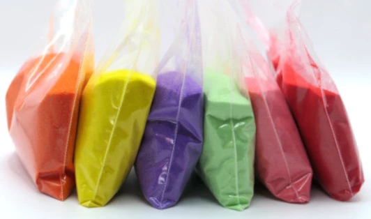 Plastic bags of multicoloured sand.