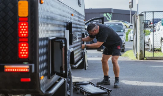 Man working on a vehicle.