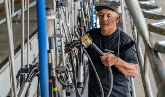 Farm worker handling equipment.