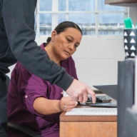 Office worker looking at files on desk.